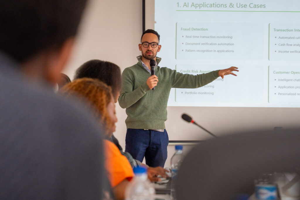 Josh Allen, CTO of Pezesha, presenting on AI ecosystem in Kenya at the PEDL Workshop on AI, Finance and Entrepreneurship; Carolyne Mweberi