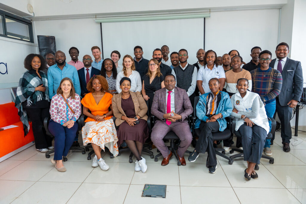 Group photo at PEDL Workshop on AI ecosystem in Kenya featuring Carolyne Mweberi, Dr. Shiko Gitau, Qhala, and Josh Allen, Pezesha